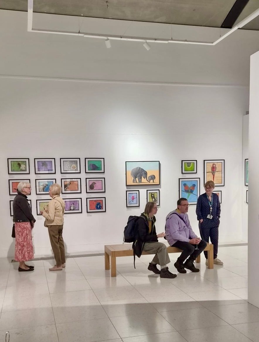People gathered in Wild Lives exhibition opening event